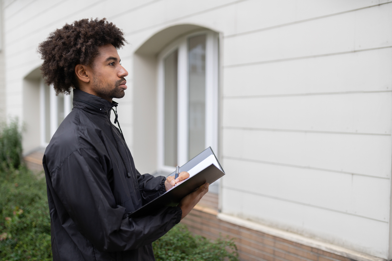 Fundraiser pausing thoughtfully on a front porch after a conversation